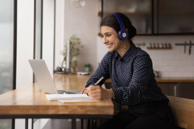 Indian woman learn english listen audio course through headphones