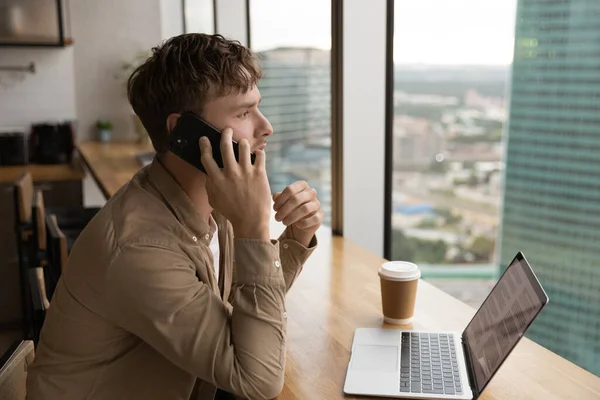 Businessman sit in modern office having conversation on the phone — Zdjęcie stockowe