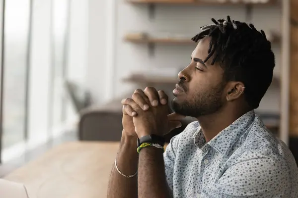 Thoughtful African male employee looks into distance and thinking —  Fotos de Stock