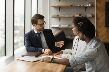 Family financial advisor consulting to African couple during meeting