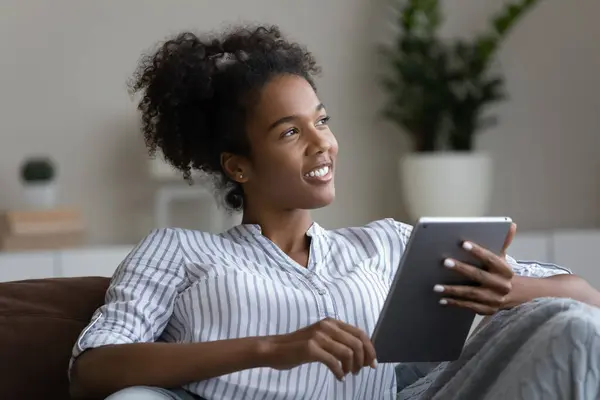 Happy ethnic woman relax at home using tablet — Foto de Stock