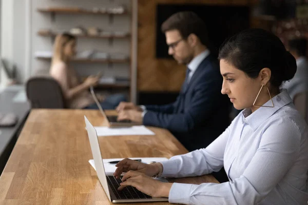 Indian woman working on computer sit in coworking space — Foto de Stock