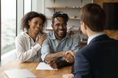 African couple shake hand financial advisor after sign contract