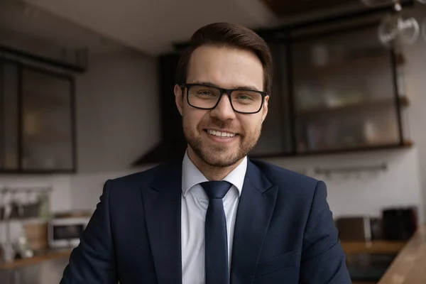 Headshot confident 30s businessman in suit smile look at camera — ストック写真