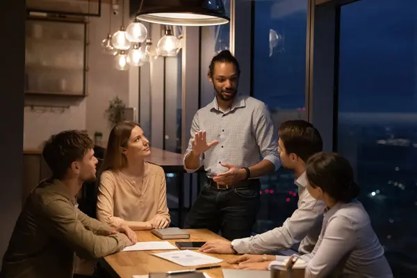 Group of diverse employees working in office boardroom until late — Foto Stock