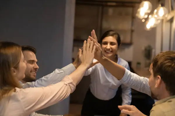 Diverse colleagues giving high five finish meeting late in office — Stock Photo, Image