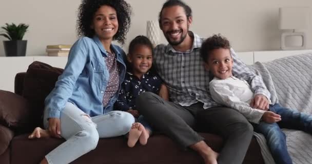 Joyful friendly multiracial family looking at camera, posing at home. — Stock video