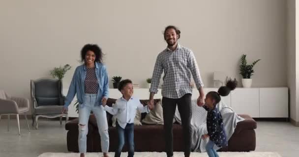 Overjoyed african american family having fun together in living room. — ストック動画