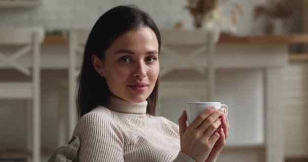 Smiling attractive young woman drinking cup of coffee. — ストック動画