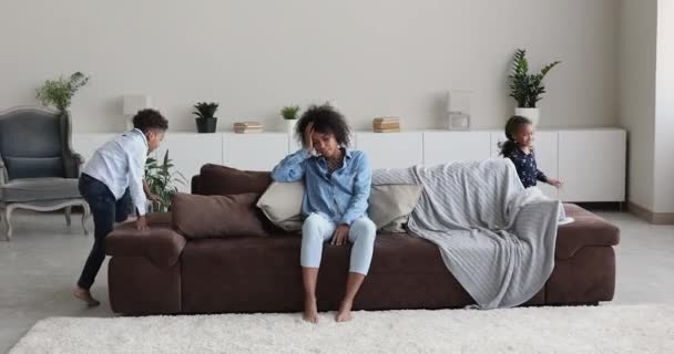 Stressed young african american mother feeling tired of noisy kids. — Wideo stockowe
