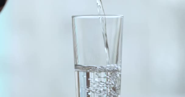 Pure fresh water poured into glass, close up background — Stok video