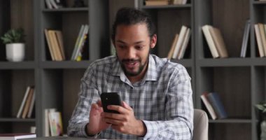 Happy young african american man celebrating online success.