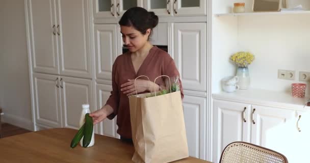 Indian woman unpack fresh natural groceries from paper shopping bag — Stock video