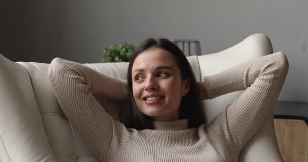 Happy mindful young beautiful woman resting in comfortable armchair. — Stockvideo