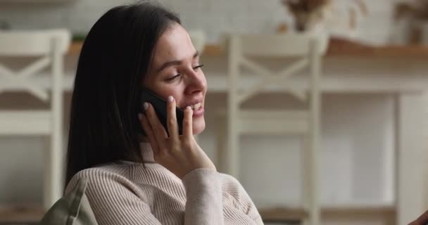 Smiling millennial relaxed woman holding phone call conversation. — Stock video