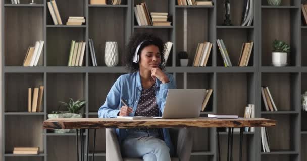 Happy millennial african woman studying online on computer. — Video