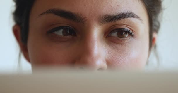 Indian female looking at laptop screen, closeup view face part — Vídeos de Stock