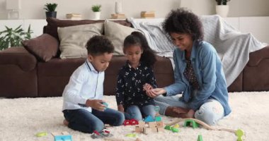 Joyful single mixed race mum playing with little children.