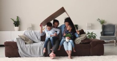 Happy african american family celebrating moving into new renovated apartment.