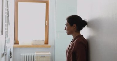 Indian female hiding alone in laundry room experiencing personal troubles