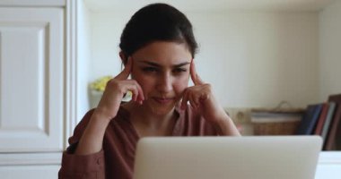 Indian woman search and find solution smiles texting on laptop