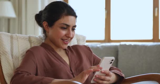 Overjoyed Indian woman receiving great news on cellphone feels excited — Video