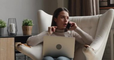 Concentrated young freelance woman working distantly, multitasking.