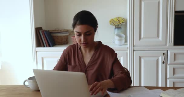 Young Indian woman working from home using laptop — Video