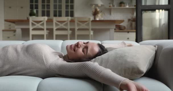 Happy positive young woman fallen on cozy couch. — Vídeo de Stock