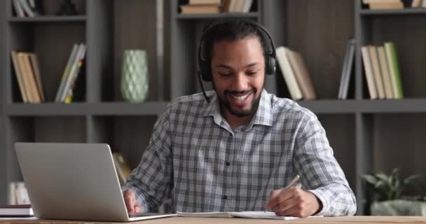 Happy millennial african man studying distantly on online courses. — Stock Video