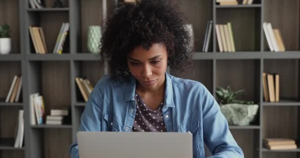Thoughtful millennial african woman studying on computer. — Stockvideo
