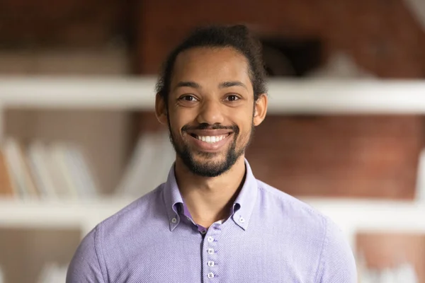 African male employee head shot portrait in modern office — Stock Photo, Image