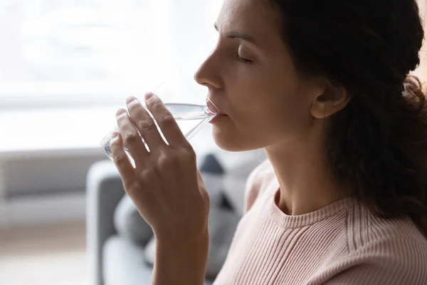 Woman holding glass drinking water, close up side view face — Stock Photo, Image