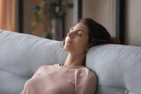 Closeup peaceful woman fall asleep leaned on comfy sofa cushion — Stock Photo, Image