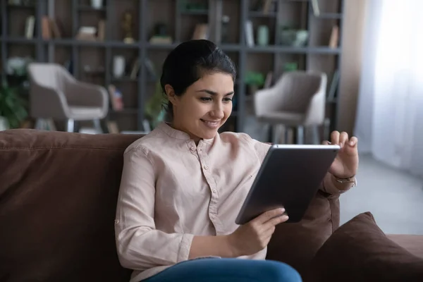 Smiling Indian woman use tablet at home — Stock Photo, Image