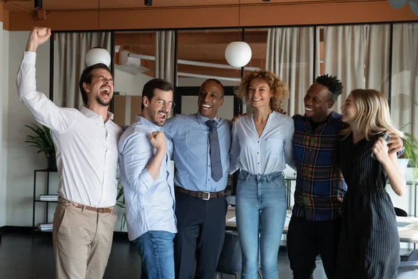 Overjoyed multiethnic team celebrate shared business success