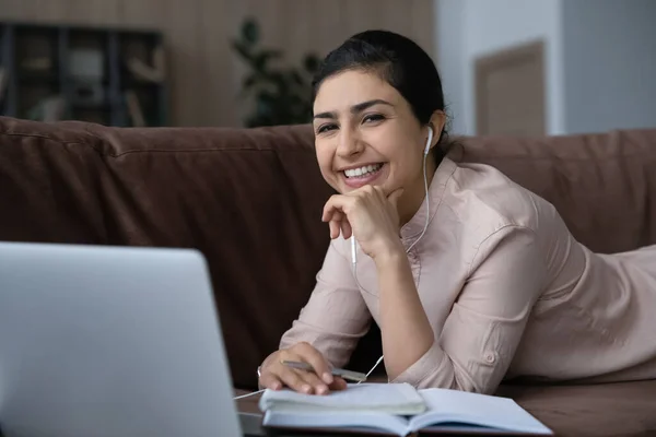 Portrait of happy Indian woman study online at home