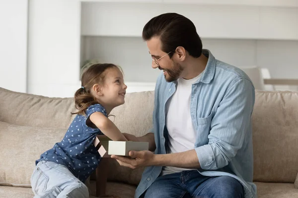 Happy dad giving gift to excited little daughter kid — Stock Photo, Image