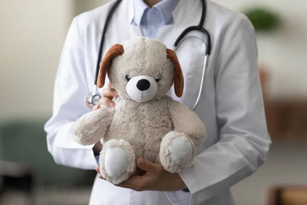 Close up focus on teddy bear in female doctor hands. — Stock Photo, Image
