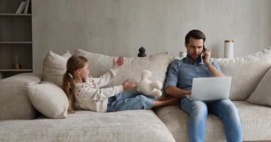 Adam, kızıyla evde çalışırken oyun oynuyor.