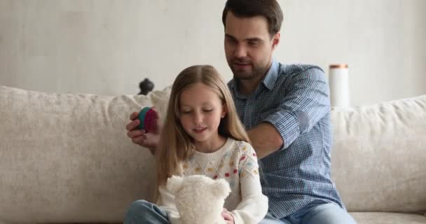 Zorgzame vader kammen lang haar van zijn kleine schattige dochter — Stockvideo