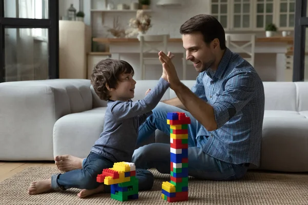 Happy millennial dad giving praise and high five to son — Stock Photo, Image