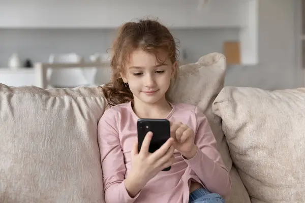 Happy little adorable child girl using cell phone. — стоковое фото