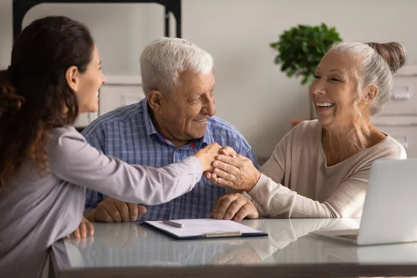 Feliz pareja de clientes mayores reuniéndose con un agente de bienes raíces — Foto de Stock