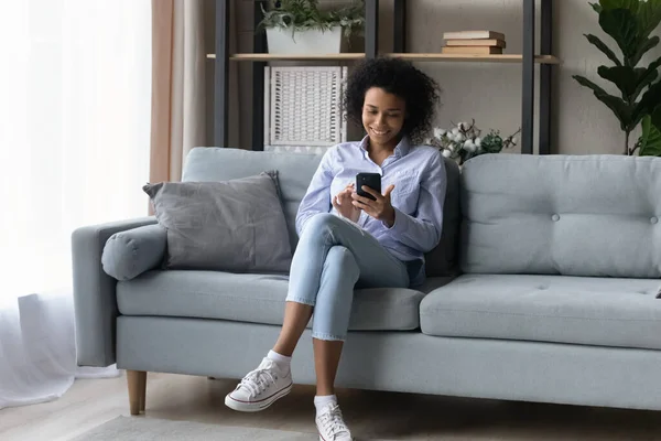 Happy young casual black lady make call on smartphone — Stok Foto