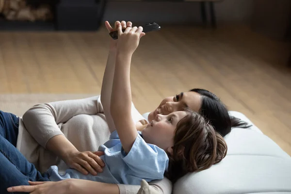 Gelukkig kleine jongen maken selfie foto met koreaanse moeder. — Stockfoto