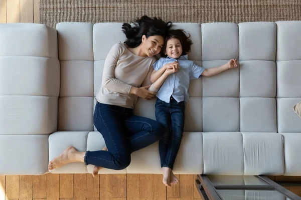 Happy millennial asian woman and little son resting on sofa. — Stock Photo, Image
