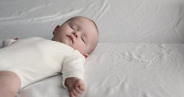 Yeni doğan yatakta uyuyor. Yakın çekim.