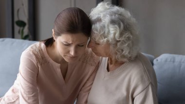 Endişeli yaşlı anne stresli kızı rahatlatıyor..