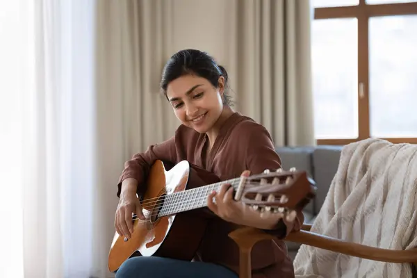 Talented young biracial female musician composing instrumental song using guitar — Stock Photo, Image